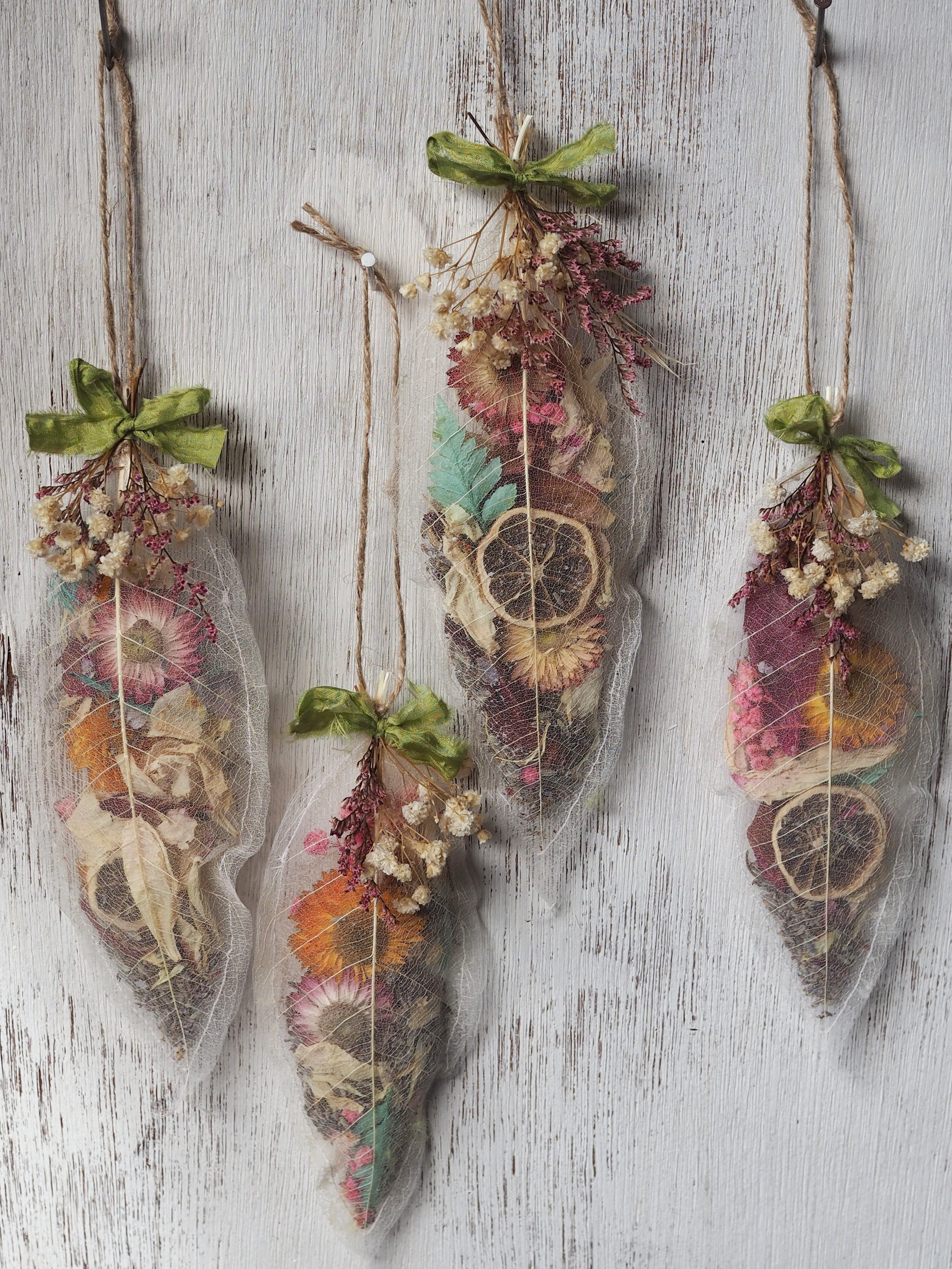 Perfume Pod A delicate pod of fragrant beauty, crafted from skeleton leaves sewn together and filled with floral potpourri.