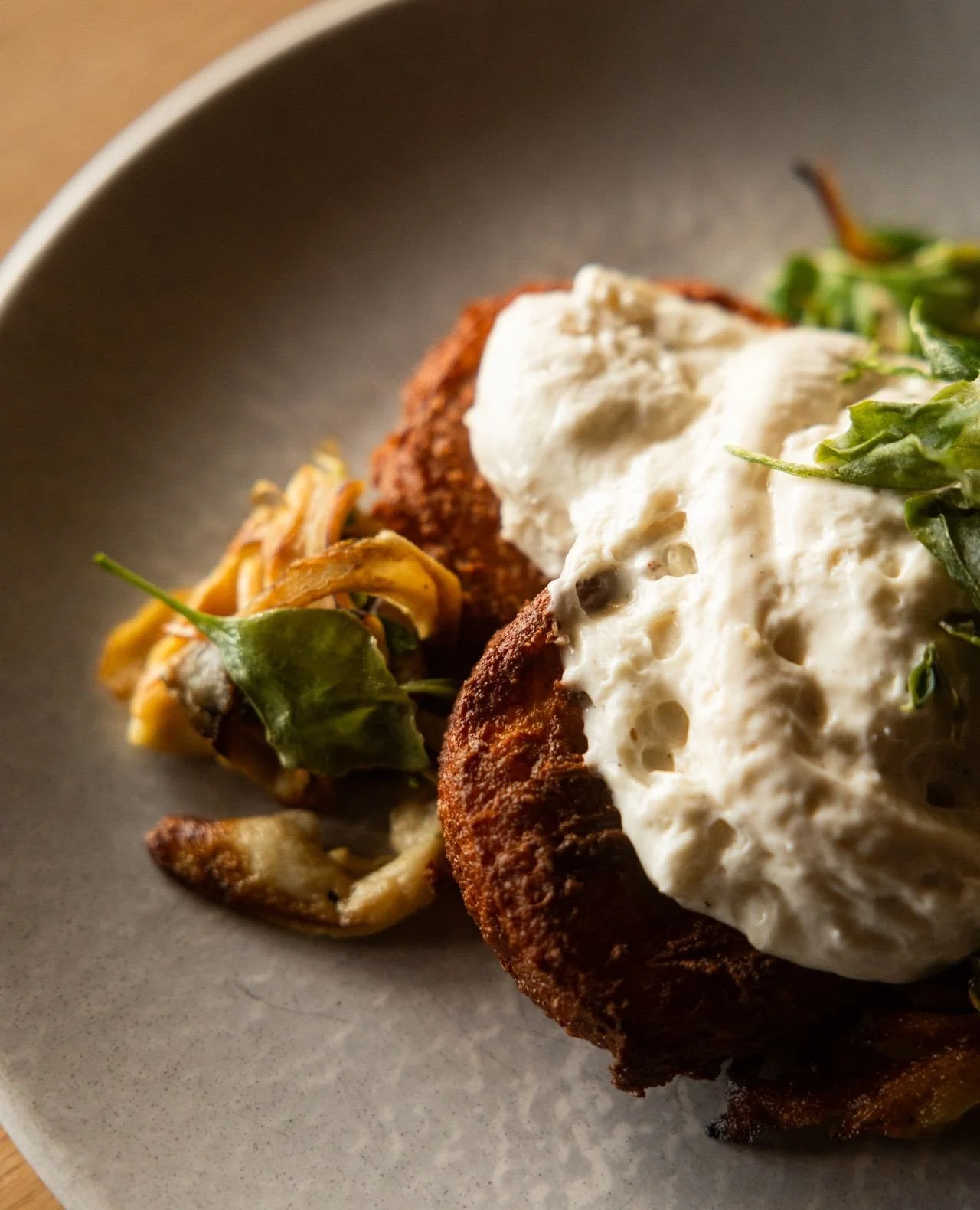 Drop in to try our Roman gnocchi.⁠
⁠
Fried semolina gnocchi fritto with saut&eacute;ed mushrooms, layered with pepperberry b&eacute;chamel and finished with crispy pops of saltbush.⁠
⁠
Enjoy it just as it is, or add your favourite extras because P.S.