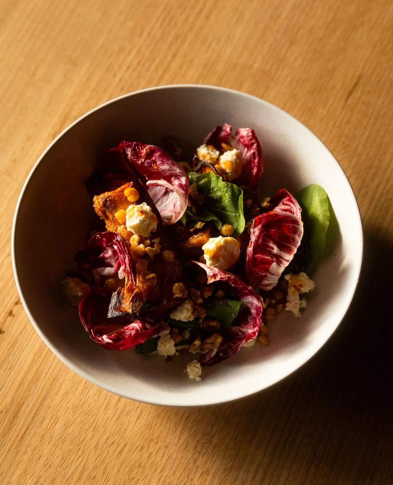 A loaded Autumn salad. ⁠
⁠
Roast pumpkin, wattleseed tahini cream, lemon myrtle ricotta, bitter leaves, toasted walnuts and crispy chickpeas, all dressed in a spicy bush tomato maple syrup.⁠
⁠
We didn&rsquo;t leave anything out of this autumn salad -
