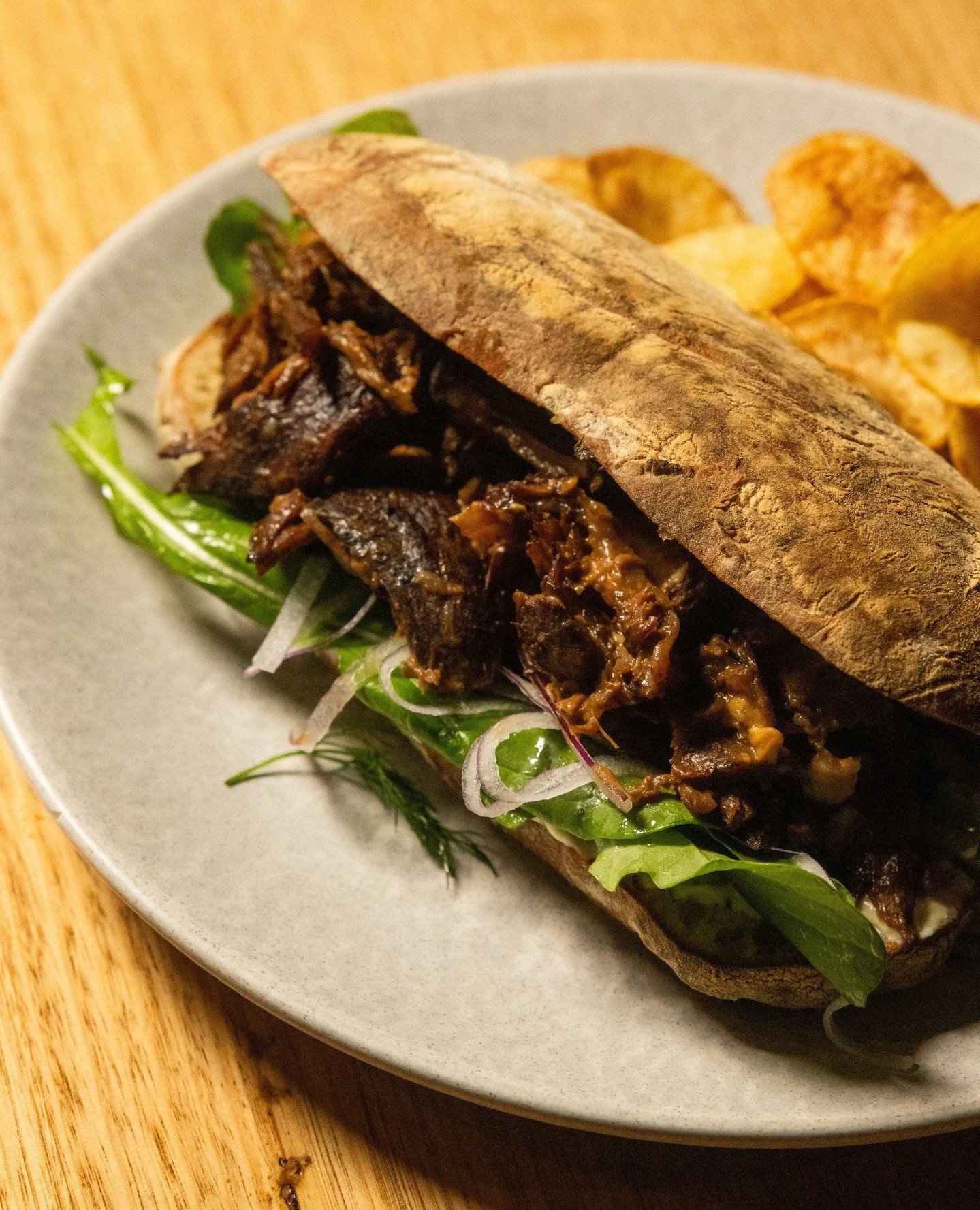 A lamb sandwich for the ages 🥩⁠
⁠⁠
We braise the lamb for 3.5 hours, bake the ciabatta fresh in-house, and load it up with whipped feta, house dijonaise, crunchy crisps, and native thyme jelly.⁠
⁠⁠
Swing by and grab one this week!