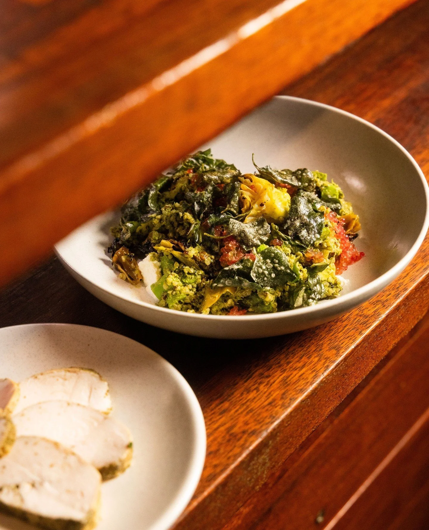 Have you tried our spring salad yet? 🌿⁠
⁠⁠
It&rsquo;s packed with charred cabbage, a medley of beans, quinoa, and native botanicals like blood lime and green tahini.⁠
⁠⁠
Make it a complete meal by adding the lemon myrtle poached chicken.