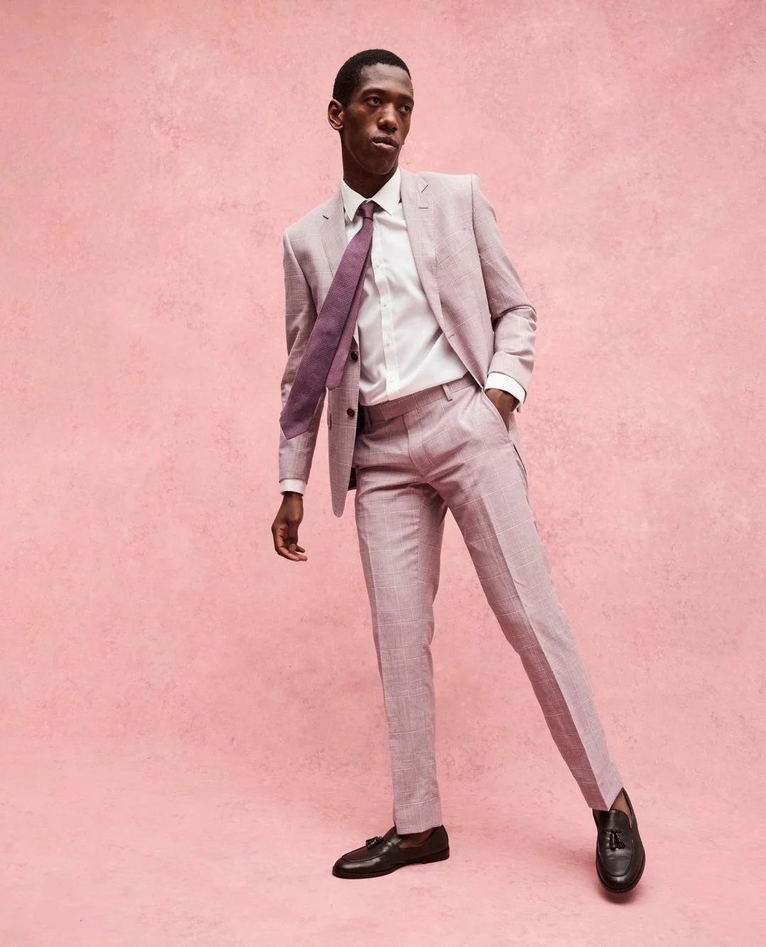 Spring event-ready. Try our pink check suit for a fresh look that's bold yet versatile.
