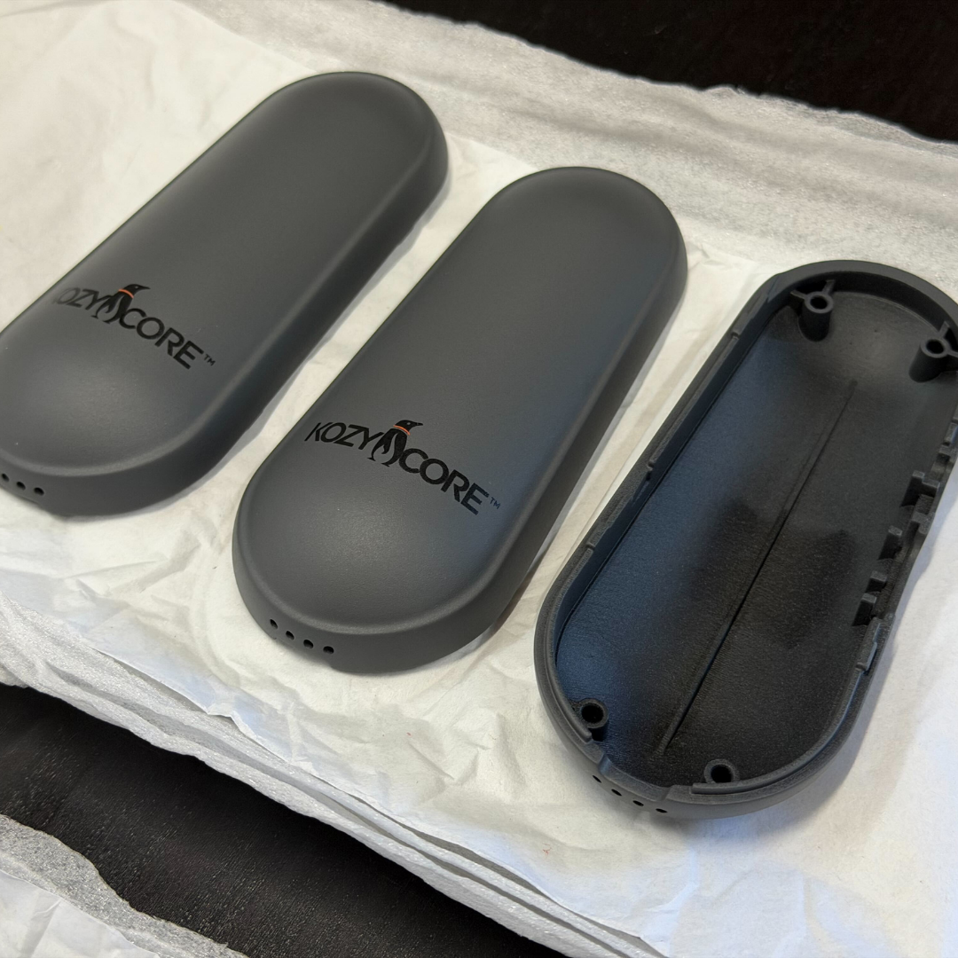 Assembled KozyCore enclosures alongside an open shell displaying the internal DFM-optimized mechanical packaging