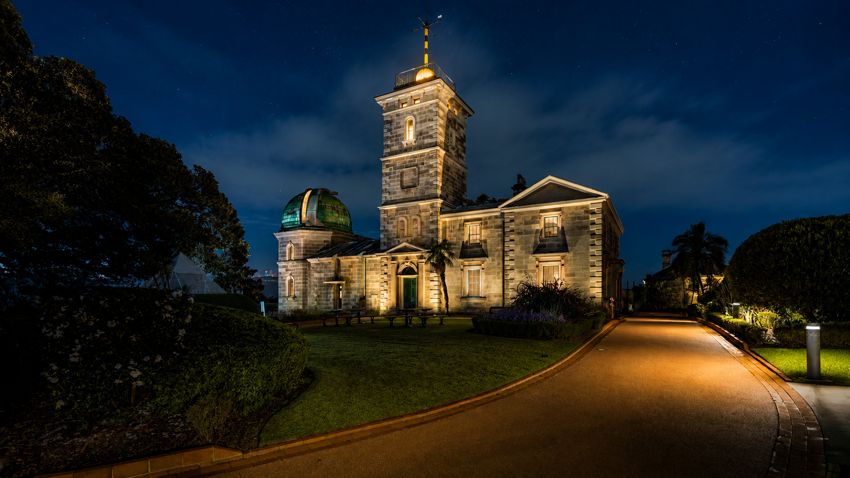 Historic observatory dome under a clear starlit sky, telescope visible inside