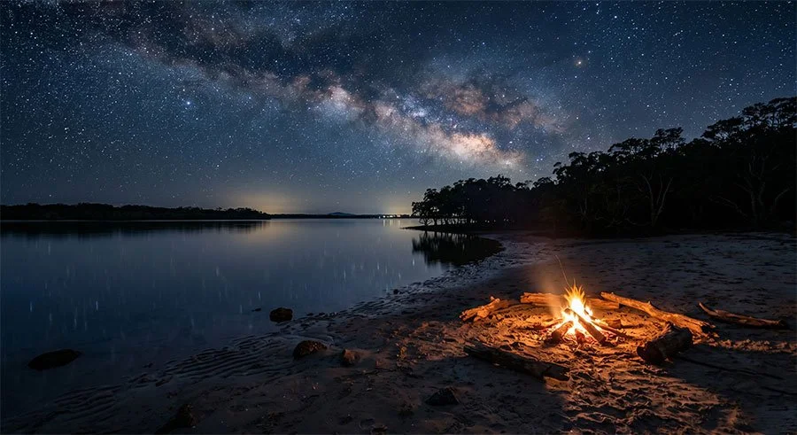 Campfire on a sandy campsite at Bribie Island with star-filled sky above Pumicestone Passage