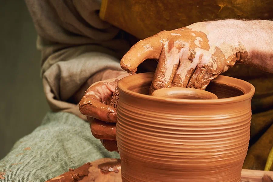 Man shaping clay on a pottery wheel, representing a creative Father’s Day pottery class experience in Brisbane