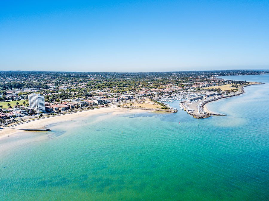 Aerial view of St Kilda Pier with Melbourne city skyline in the background, along the Port Melbourne to St Kilda coastal walking trail