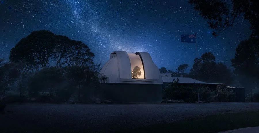 Night sky viewed through telescope eyepiece at Springbrook Research Observatory with Gold Coast hinterland rainforest in the background