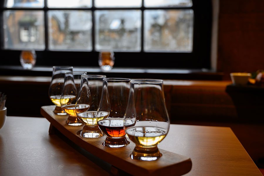 Whisky tasting glasses on a wooden board, symbolising a Father’s Day masterclass experience in Melbourne for dads who love a dram or cocktail