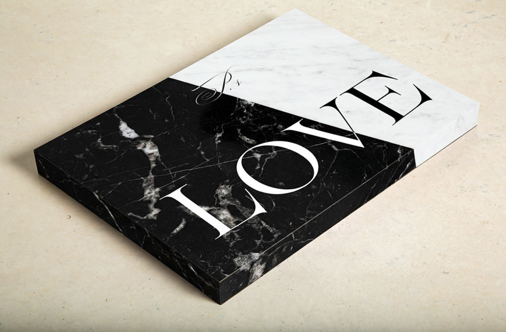 A rectangular box with a black marble pattern on one side and a white marble pattern on the other side. The box has the word "LOVE" printed on the white side in large black serif letters, with the "E" upside down.