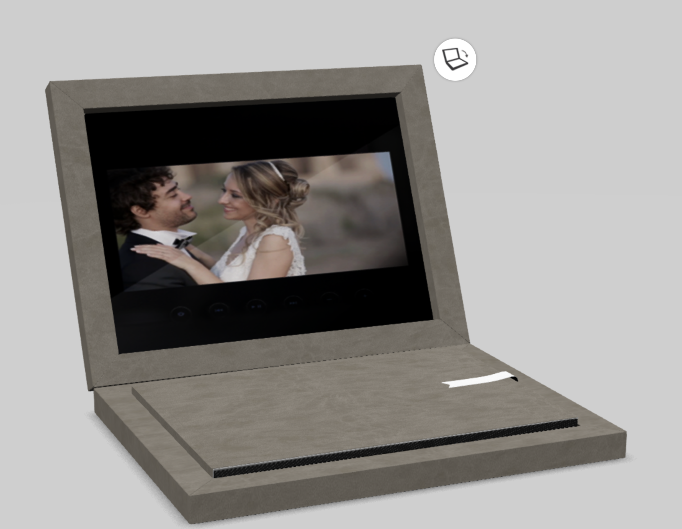 Digital photo frame displaying a wedding photo of a smiling couple, a man in a tuxedo and a woman in a wedding dress, celebrating their wedding.