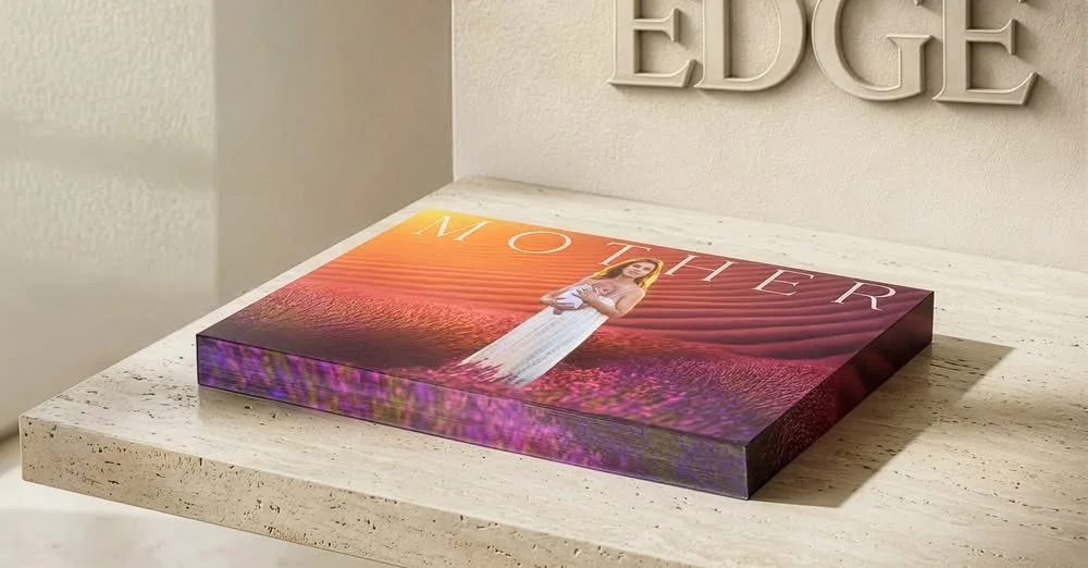 A magazine titled 'Mother' resting on a white marble surface with the word 'EDGE' on the wall behind it.