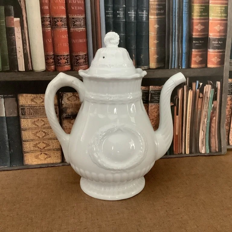 (#J149) Laurel Wreath/Victory Shape Coffee Pot; 11-1/4”H; raised impressed pad mark – Laurel Wreath – Elsmore & Forster; registered 1867.  Fine condition with two tiny spots of manufacturing grit at underside of spout which do not detract from its be