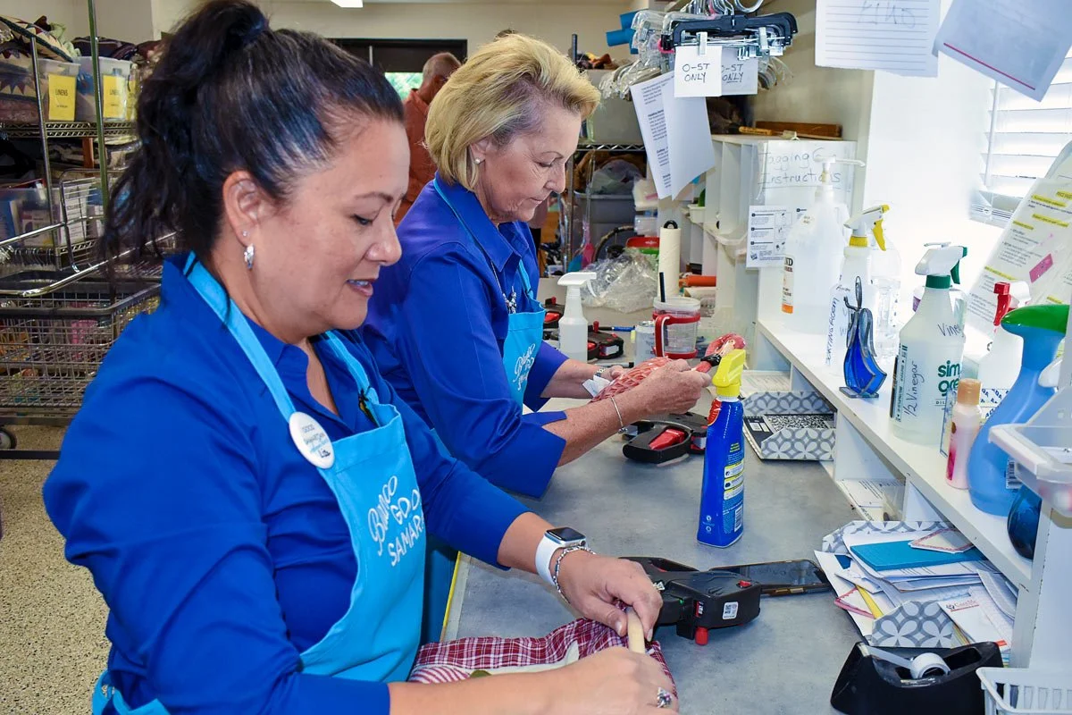 two female volunteers setting prices on merchandise at the Good Samaritan thrift store and food pantry in Blanco, Texas