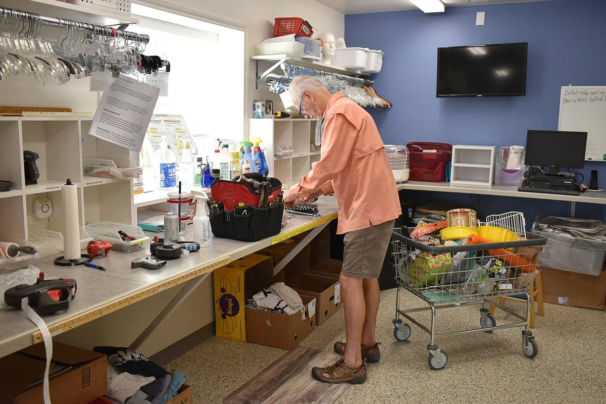 male volunteer working at the repair shop at the Good Samaritan thrift store and food pantry in Blanco, Texas