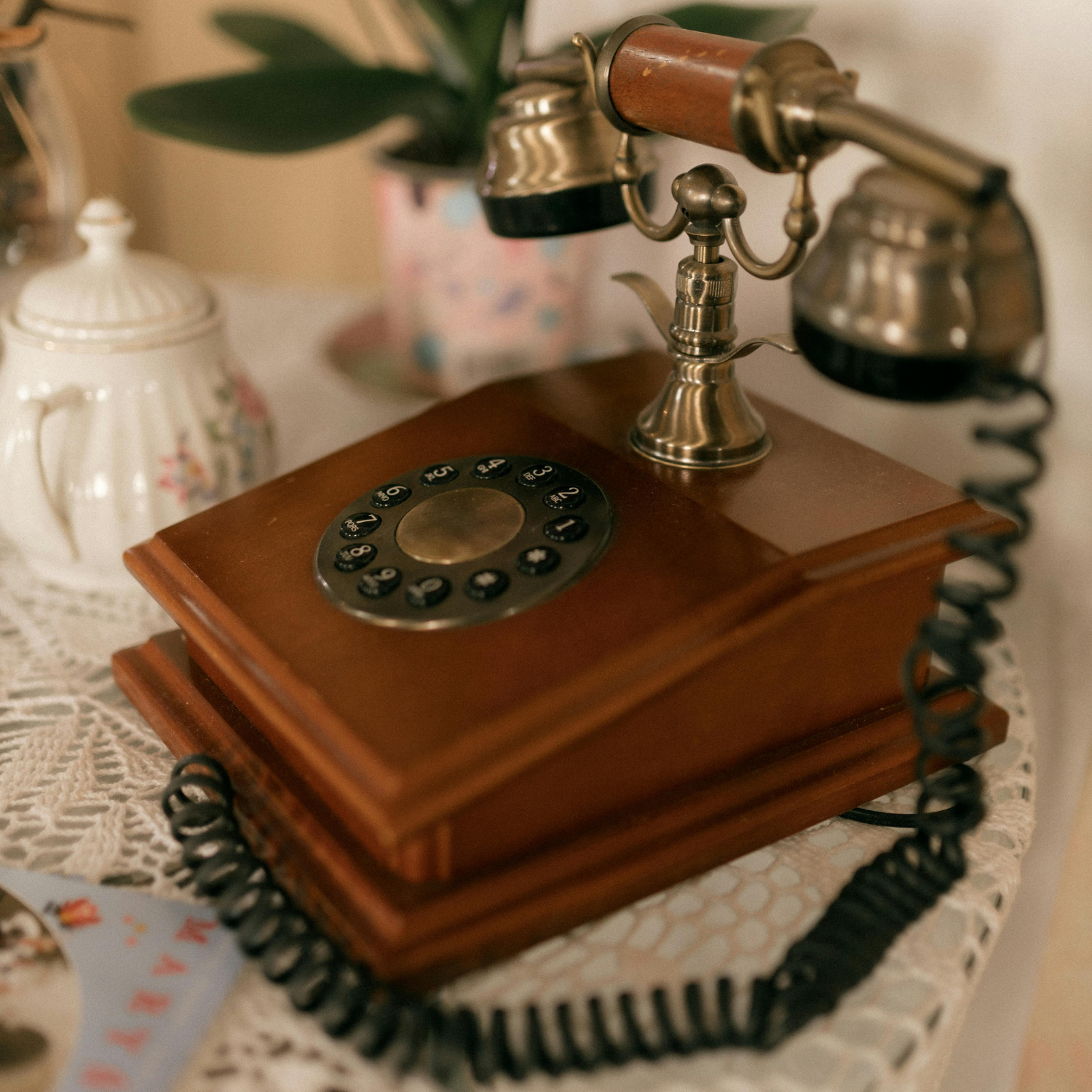 Vintage rotary phone made of beautiful wood on antique-style table