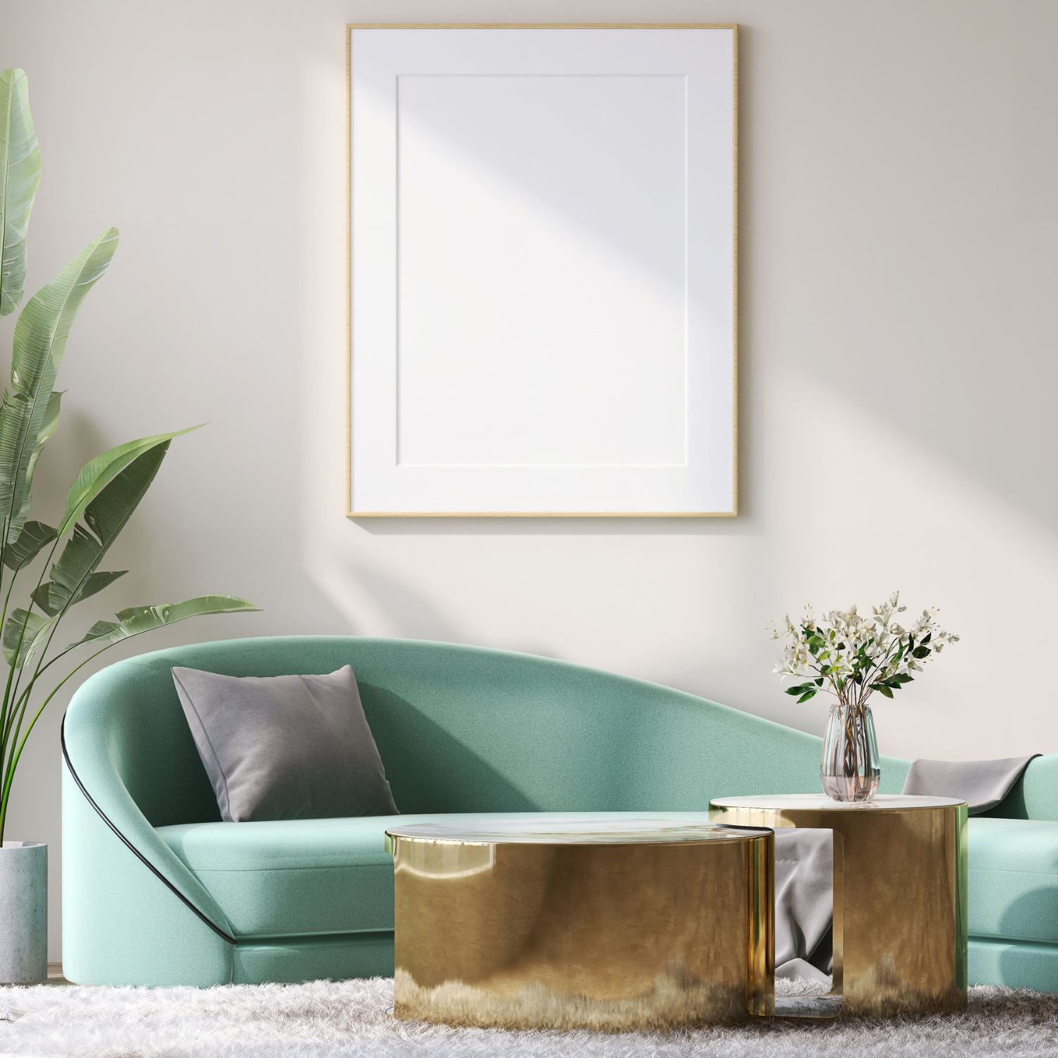 Modern sea foam green lounge couch with broad leafed plant and coffee table, soft cream rug and solid white art on wall with thin gold frame