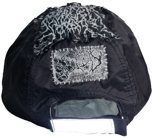 Black cap with patches of fabric featuring spiderweb-like embroidery on the back.