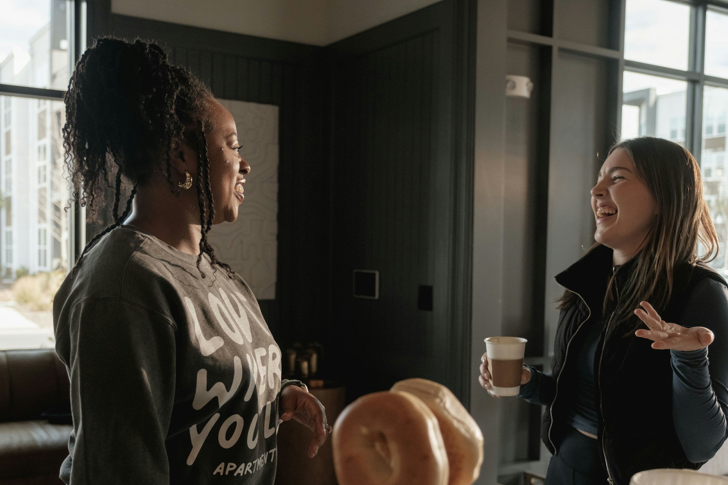 Two women talking, laughing together