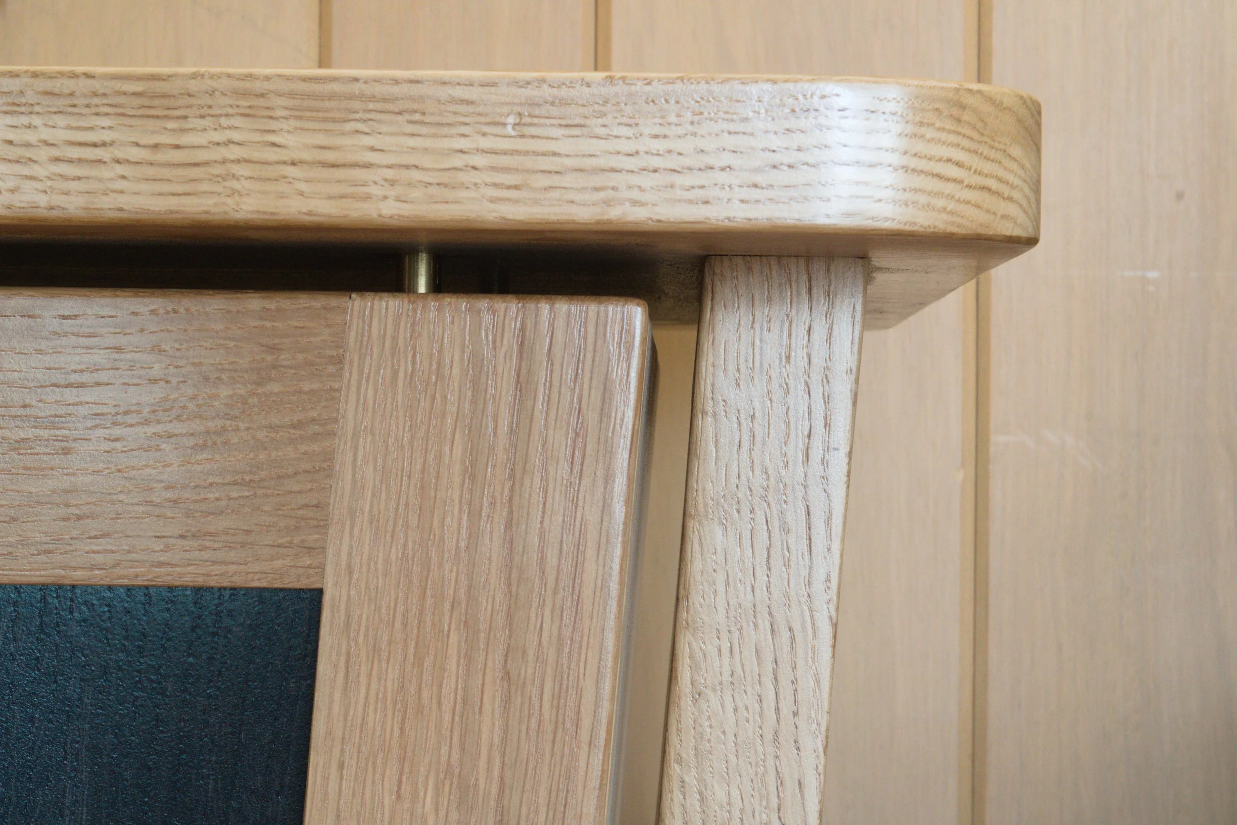 Close-up of a wooden table corner showing the natural wood grain and joinery details.