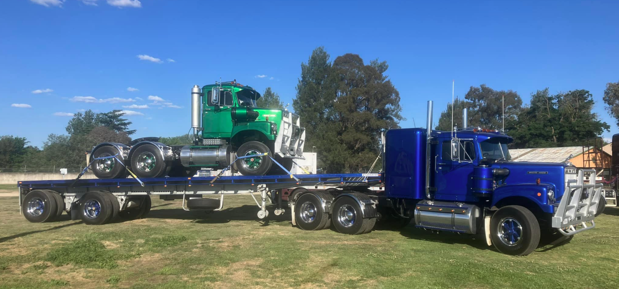 White 4000 with truck on trailer.png