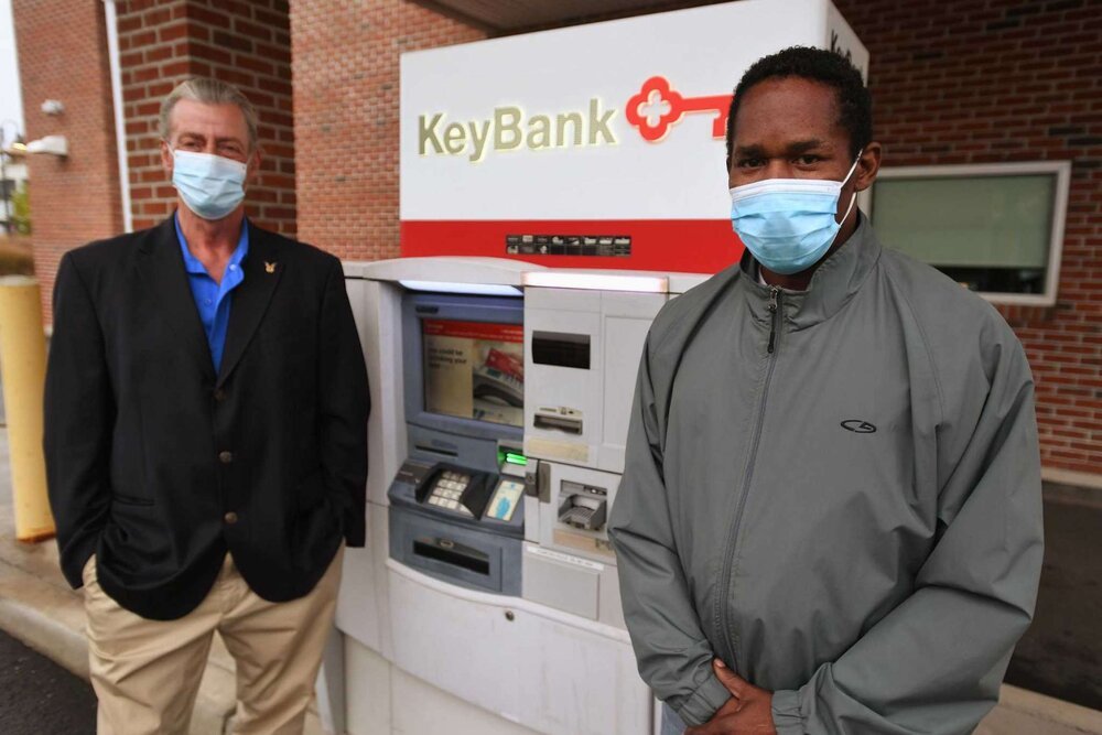  Leon Standly, left, and Kenneth Moss at the Key Bank on Canal Street in Stamford, Conn. on Monday, October 12, 2020. Standly, a Pacific House Shelter resident, helped Moss get a hassle free account at the bank after developing a relationship with a 