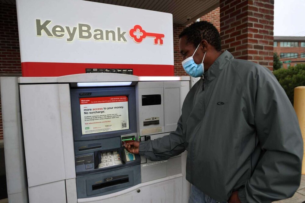 Kenneth Moss uses the ATM at the Key Bank on Canal Street in Stamford, Conn. on Monday, October 12, 2020. Moss' friend Leon Standly, a Pacific House Shelter resident, helped Moss get a hassle free account at the bank after developing a relationship 