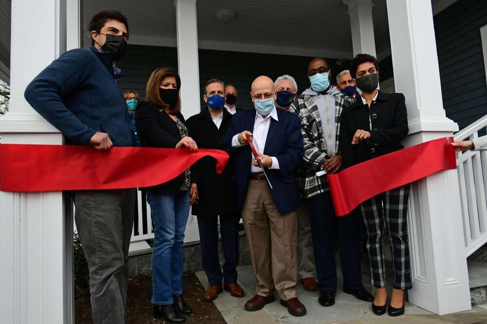  Local and state officials join Executive Director Rafael Pagan, center, as Pacific House holds a ribbon cutting ceremony Friday, April 16, 2021, for a new property with 12 units of housing for formerly homeless individuals in Norwalk, Conn.  Photo: 