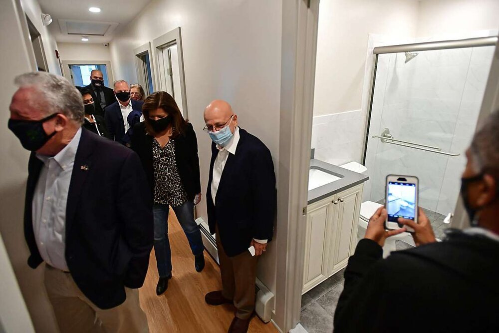  Local and state officials join Executive Director Rafael Pagan, center, for a tour as Pacific House holds a ribbon cutting ceremony Friday, April 16, 2021, for a new property with 12 units of housing for formerly homeless individuals in Norwalk, Con