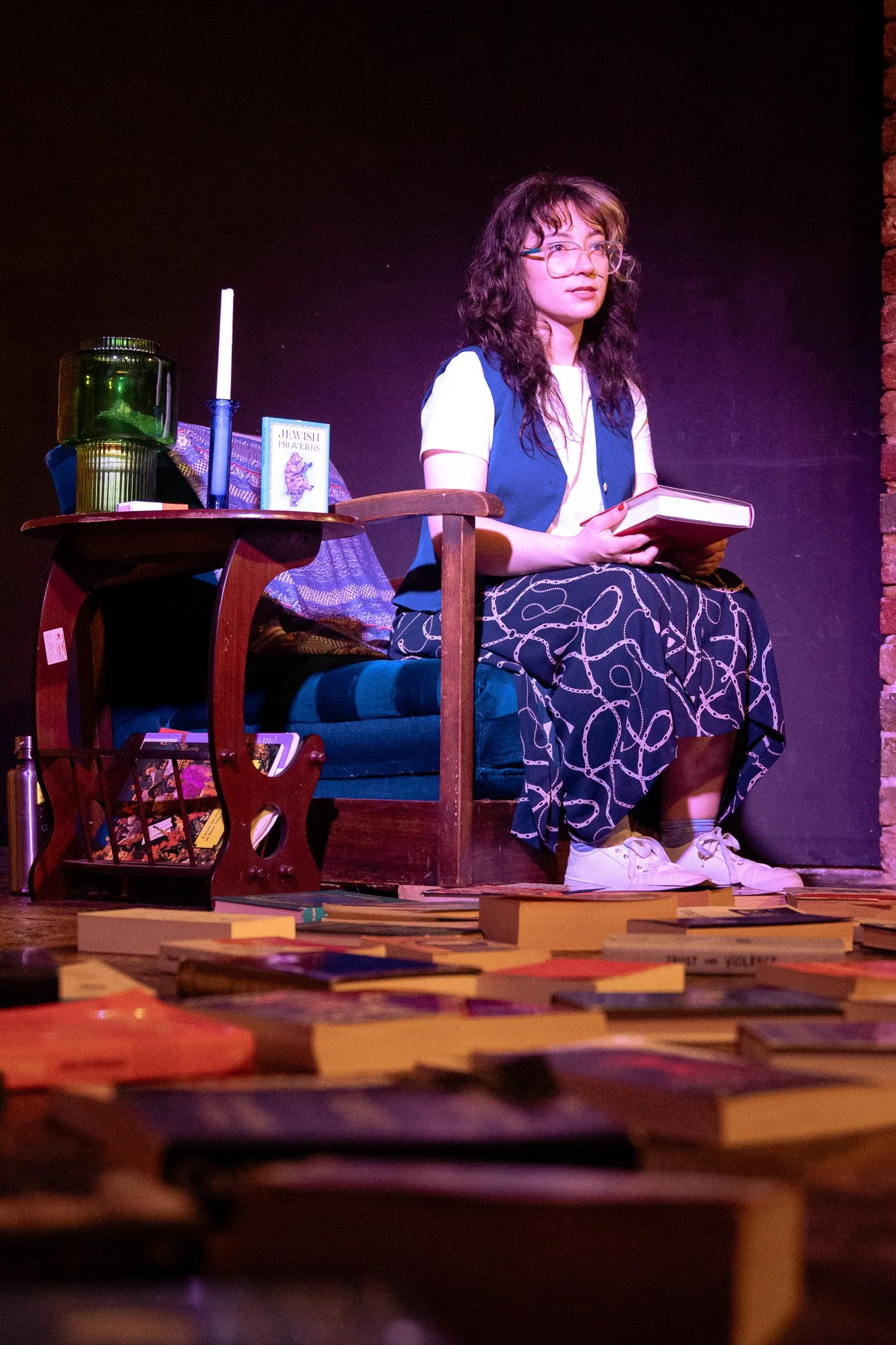 Emotive portrait from “NUSIA,” capturing the lead performer expressing vulnerability as she navigates her character’s search for self and connection to ancestry. Warm theatrical lighting enhances the mood