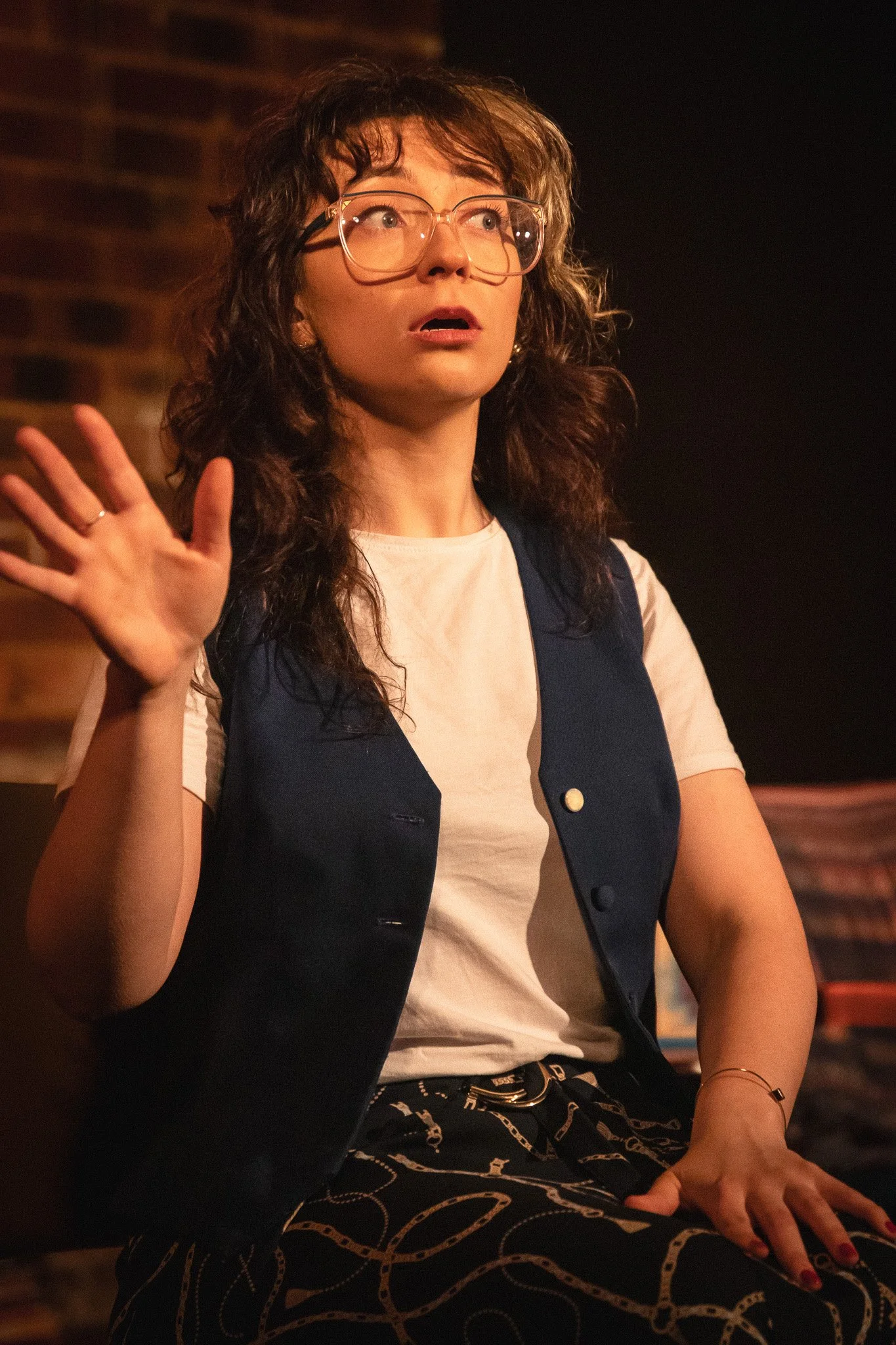 Dynamic production still from “NUSIA,” a one-woman play blending humour and heartfelt introspection. The performer moves through the space, embodying different chapters of her character’s identity and lived experiences