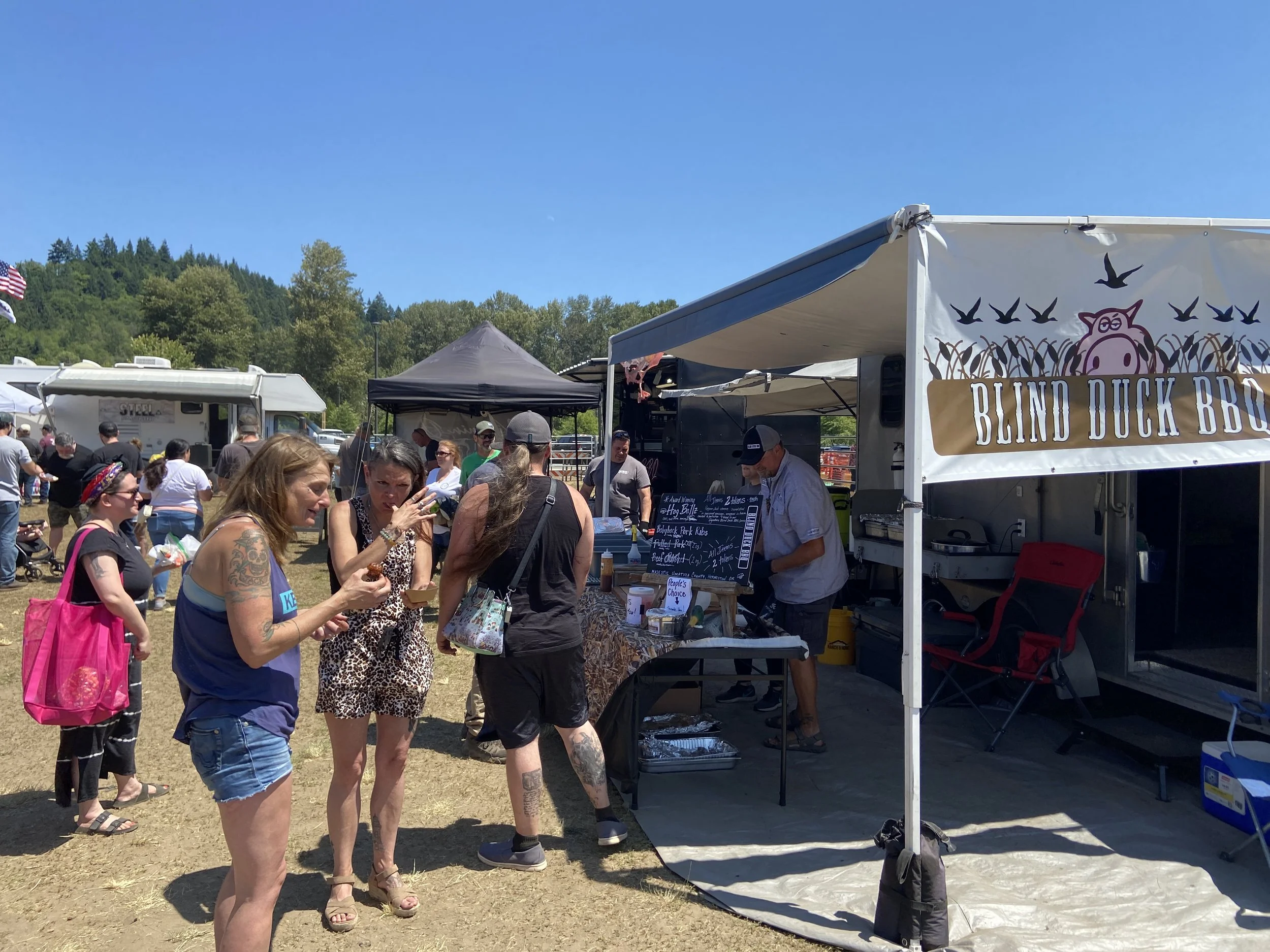 People lined up at the Blind Duck BBQ tent on tasting day at the Big Smoke in Little Kalama PNWBA competition.