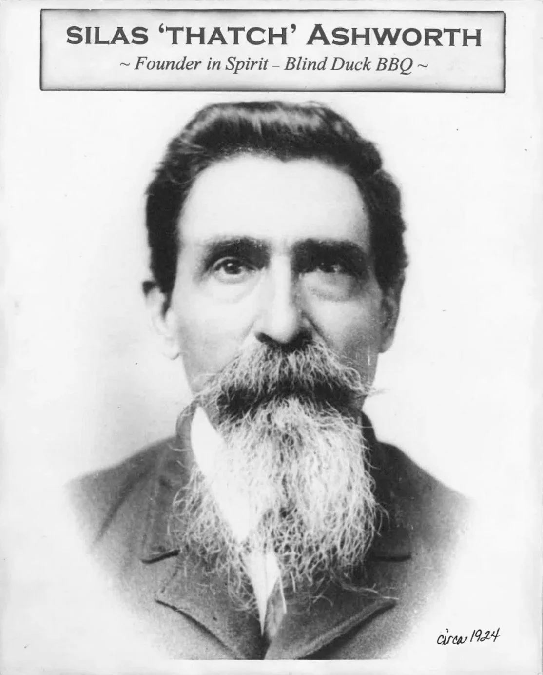Black and white historical photograph of Silas 'Thatch' Ashworth with a full beard and mustache, date circa 1924, featuring a sign with his name and description at the top.