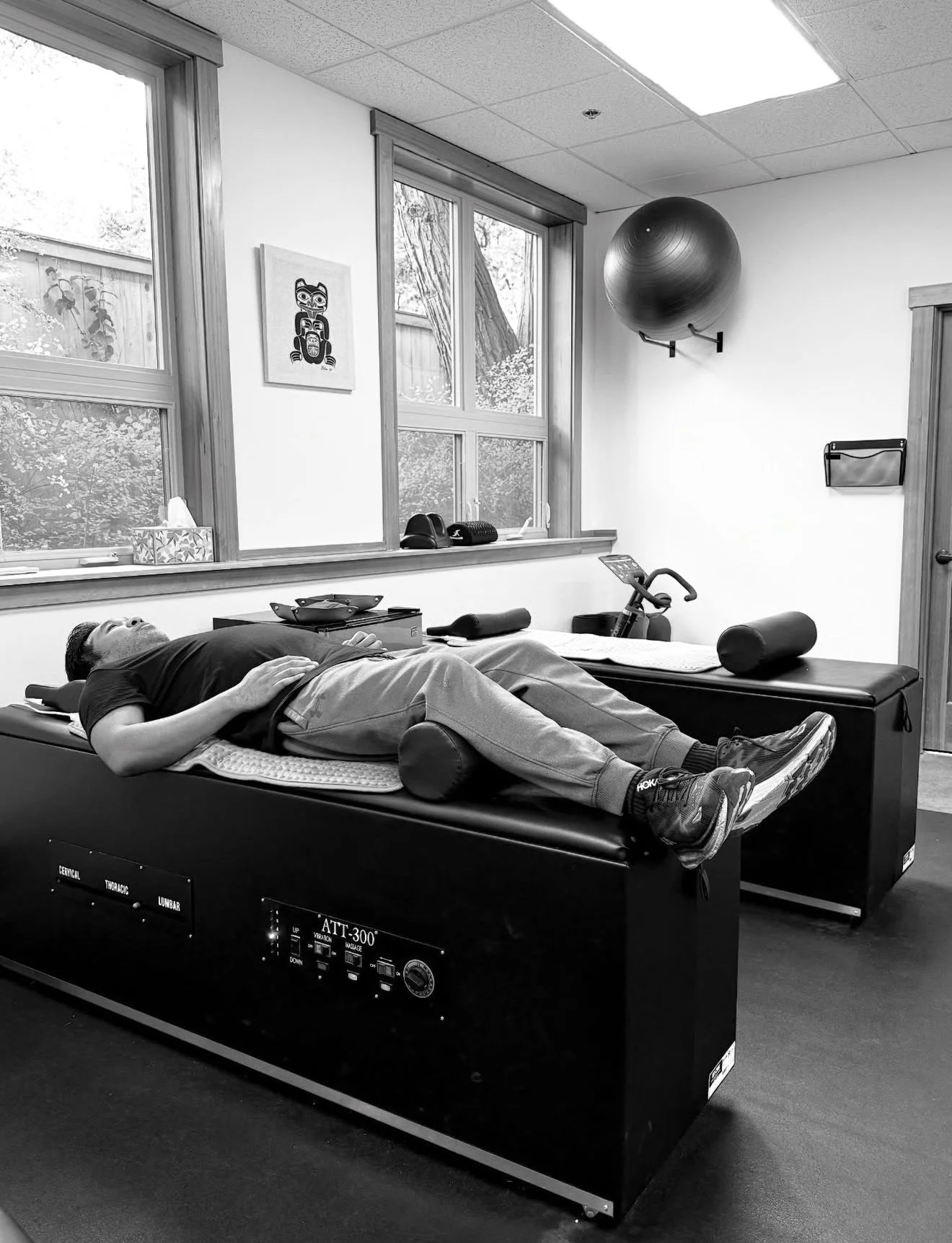 A patient laying on a mechanical traction table for spinal health.