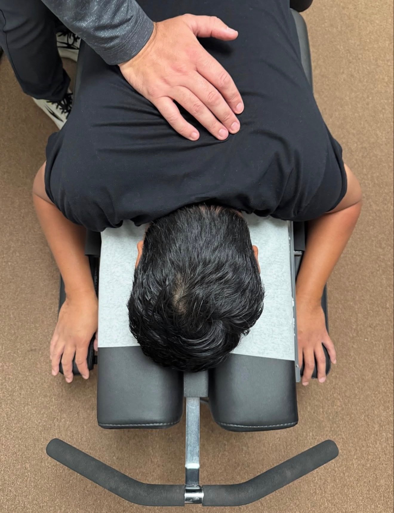 Dr. Jeremiah Aden palpating and examining a patient.t