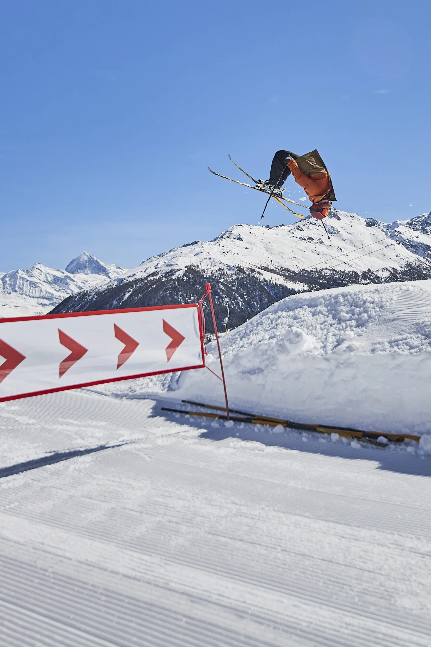 Snowboarder performing above a terrain-park edge — photograph by Michaël Gramm
