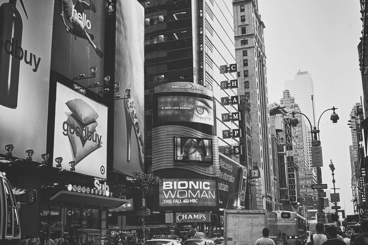 Busy street with theater signs and tall buildings — New York & Washington series — photograph by Michaël Gramm