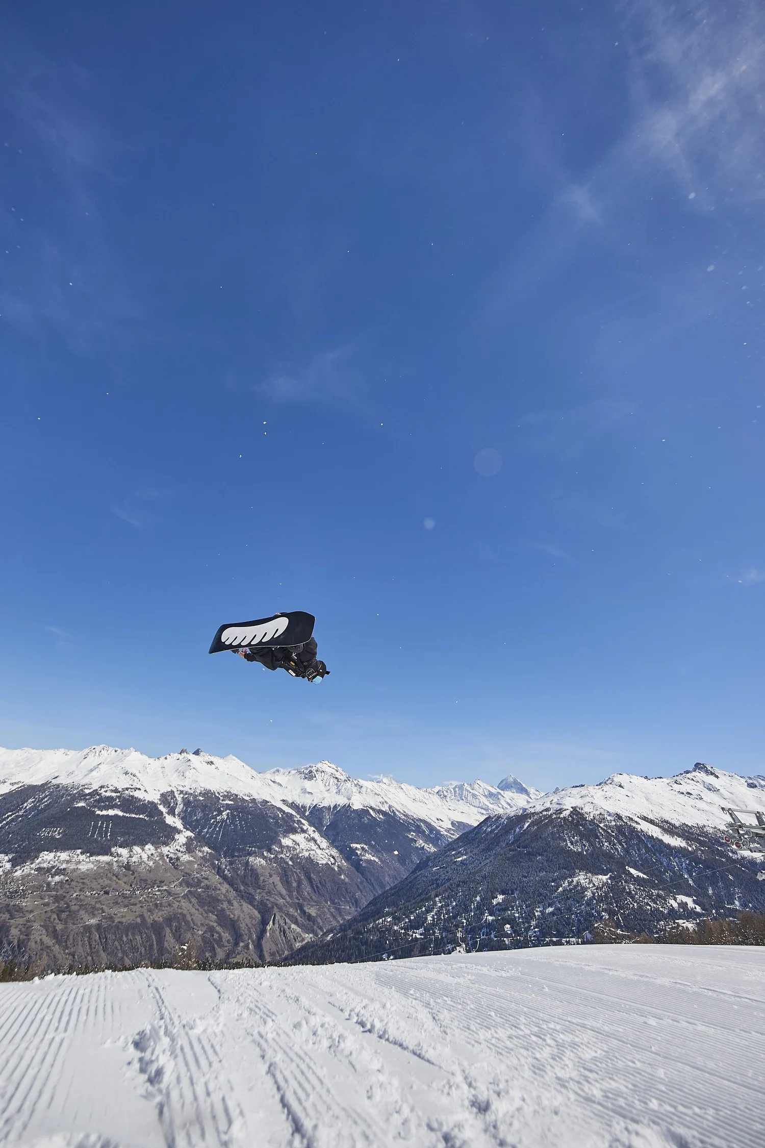 Distant rider silhouetted against the blue sky — Snow series — photograph by Michaël Gramm