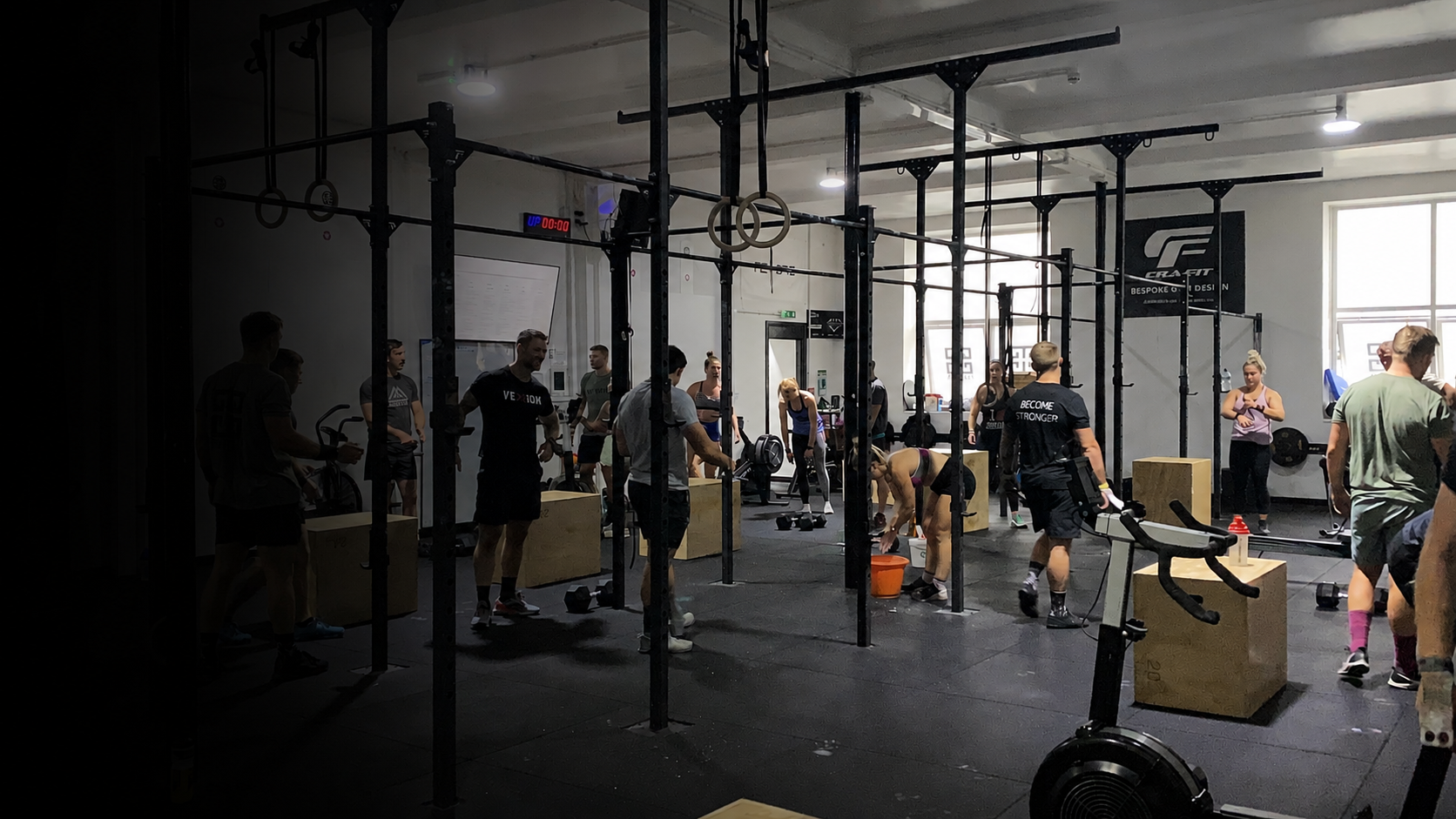 CrossFit class in progress at Pantheon Plymouth, featuring members training on a large functional fitness rig with coached workouts, strength training equipment and a supportive community atmosphere in Plymouth, Devon.
