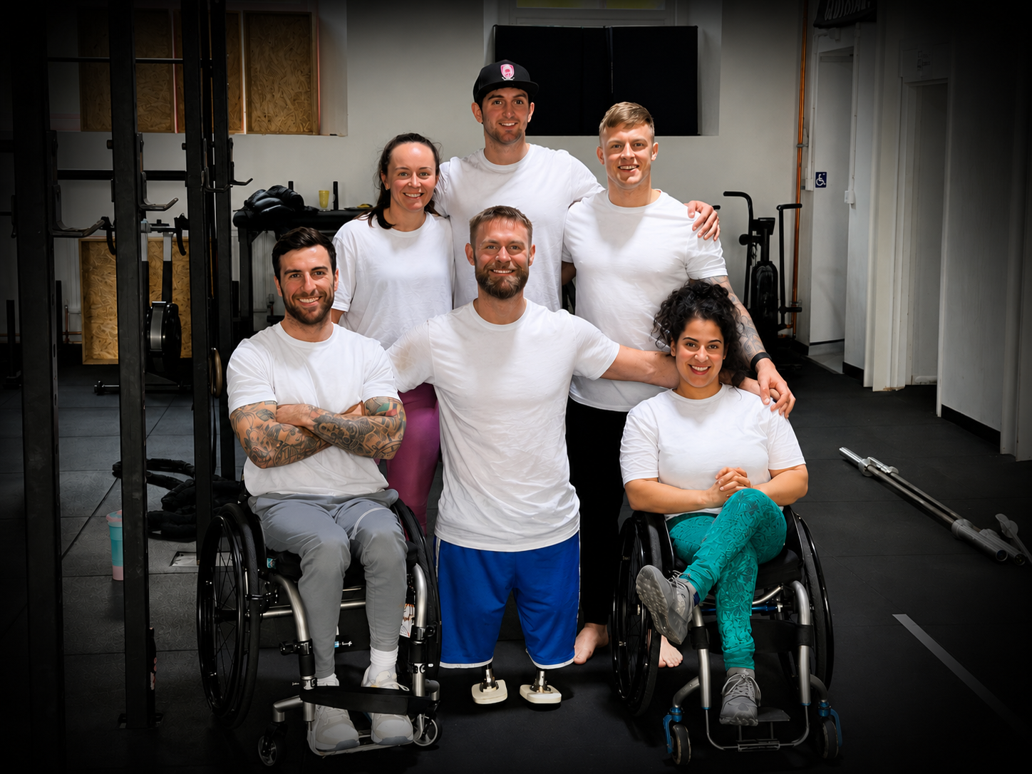 Inclusive fitness group at Pantheon Plymouth featuring wheelchair users and standing participants in a gym environment, highlighting adaptive training, accessible fitness and community support.