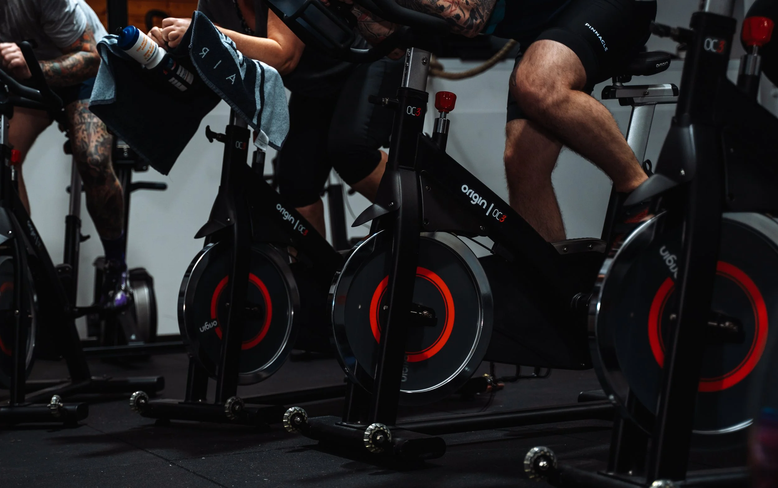 Indoor spin class at Pantheon Plymouth with members using high-performance exercise bikes in a coached group fitness session in Plymouth, Devon.