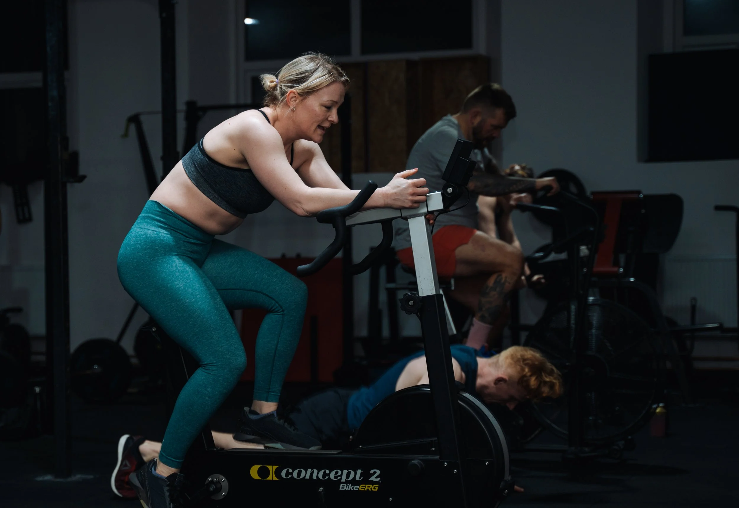 Member taking part in a coached indoor cycling session at Pantheon Plymouth gym, using a Concept2 BikeErg during a group fitness class in Plymouth, Devon.