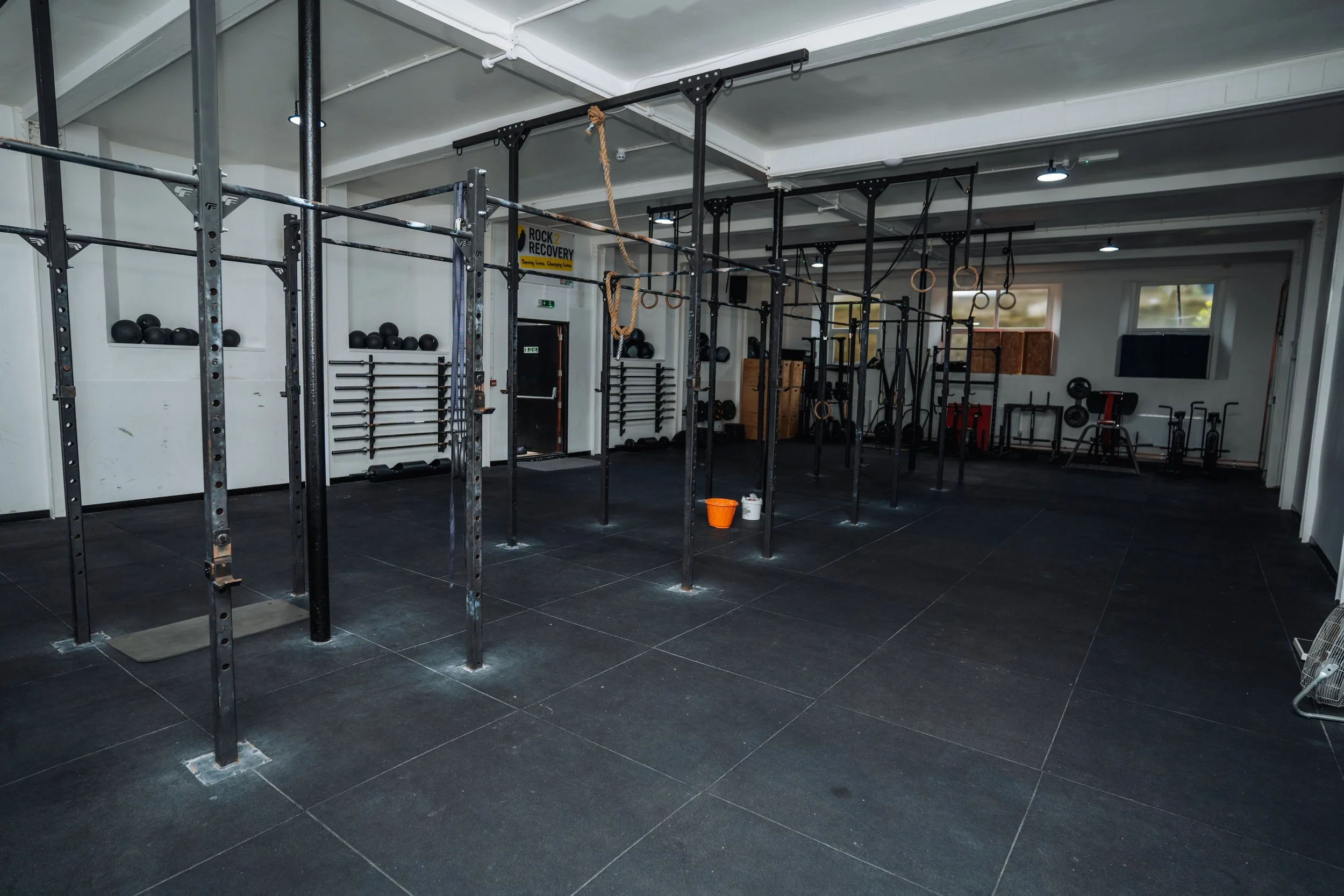 Main functional fitness training area at Pantheon Plymouth featuring a large CrossFit rig, gymnastic rings and open workout space for strength and conditioning classes in Plymouth, Devon.