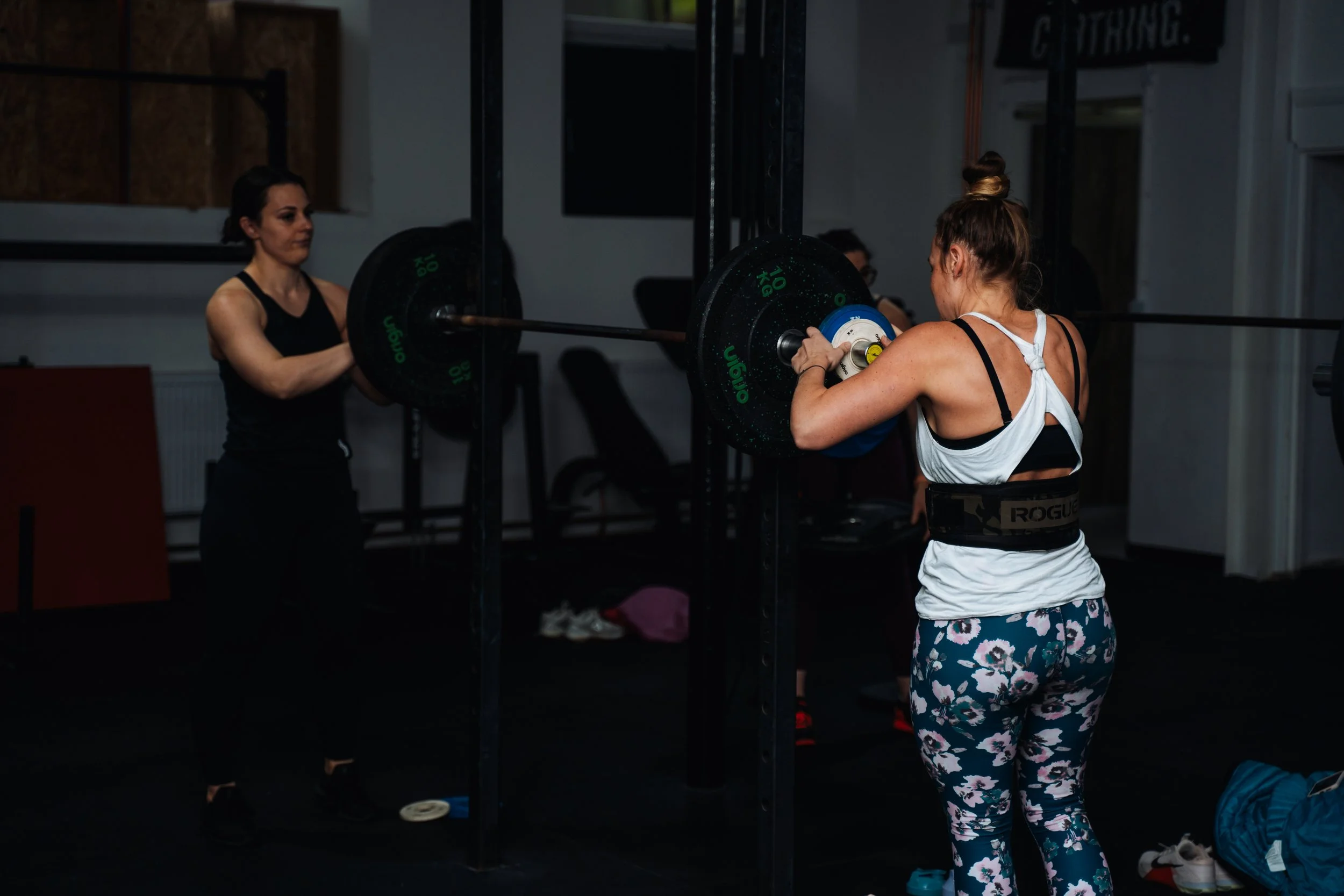 Women participating in a coached barbell strength training session at Pantheon Plymouth, an inclusive fitness gym in Plymouth offering Olympic lifting, CrossFit, strength and conditioning classes.