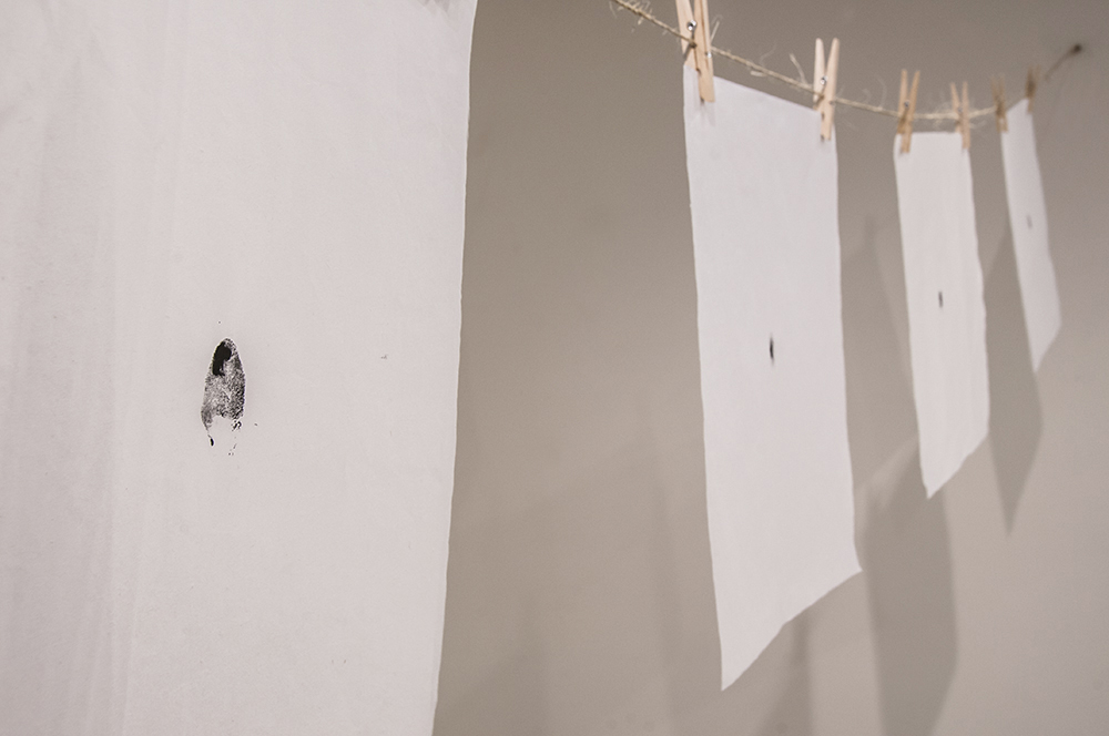 지문 (jē•mōōn): Exploring Equality in South Korea. Stamped ink thumbprints on mulberry fiber paper hung from twine and clothespins.