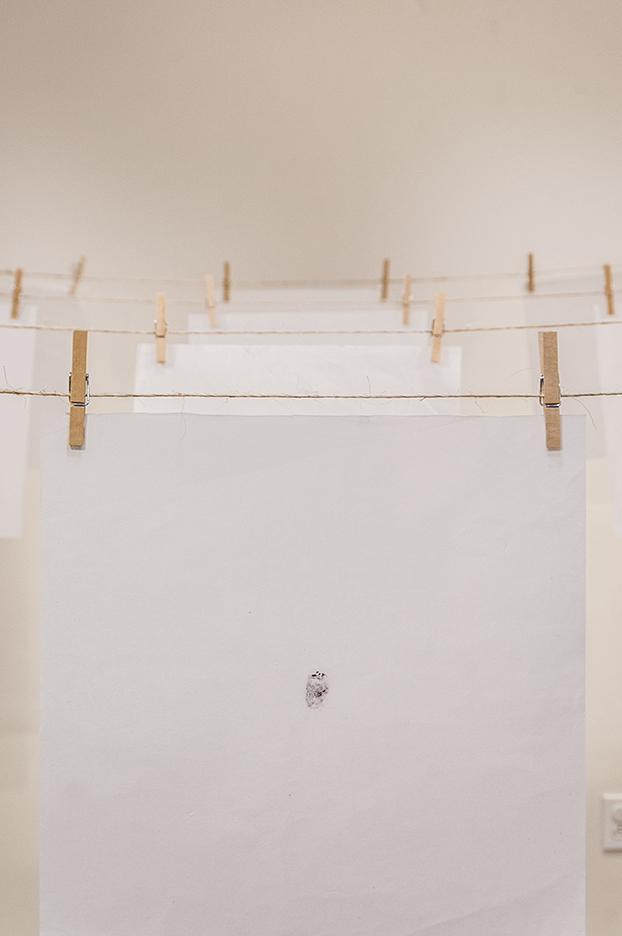 지문 (jē•mōōn): Exploring Equality in South Korea. Stamped ink thumbprints on mulberry fiber paper hung from twine and clothespins.