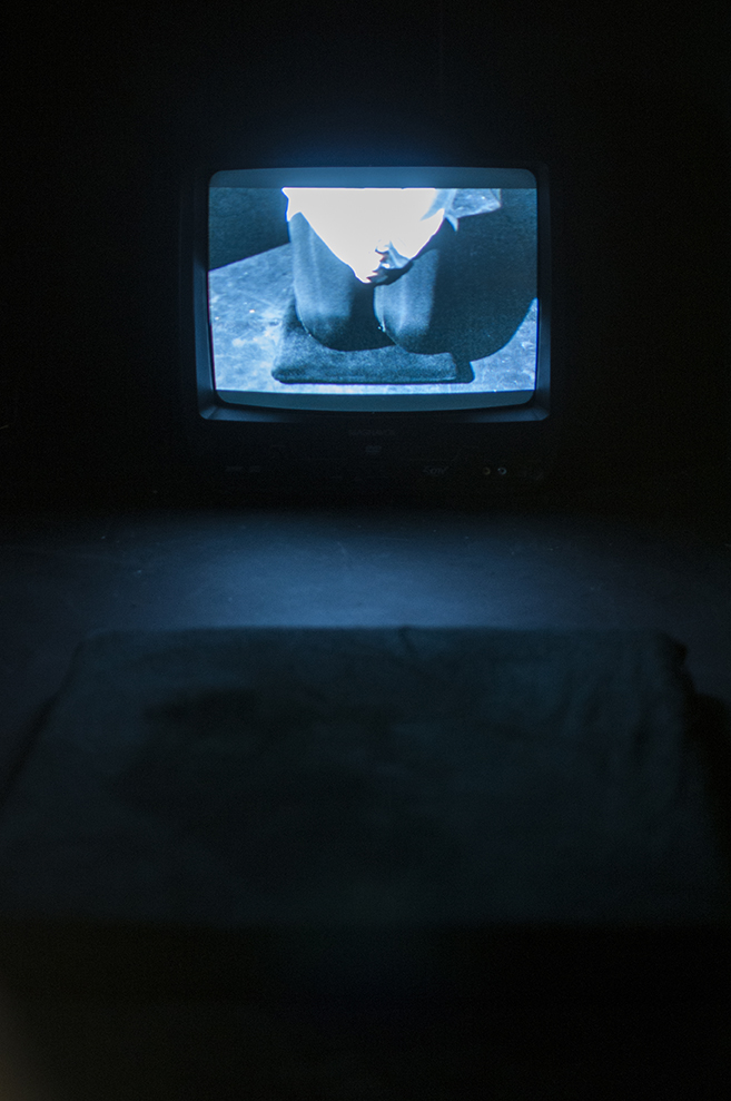  Hyphen (self-portrait)&nbsp;  Multimedia installation: projection, sound, television, DVDs in a constructed room 96x125x96 inches.  Installation view. 