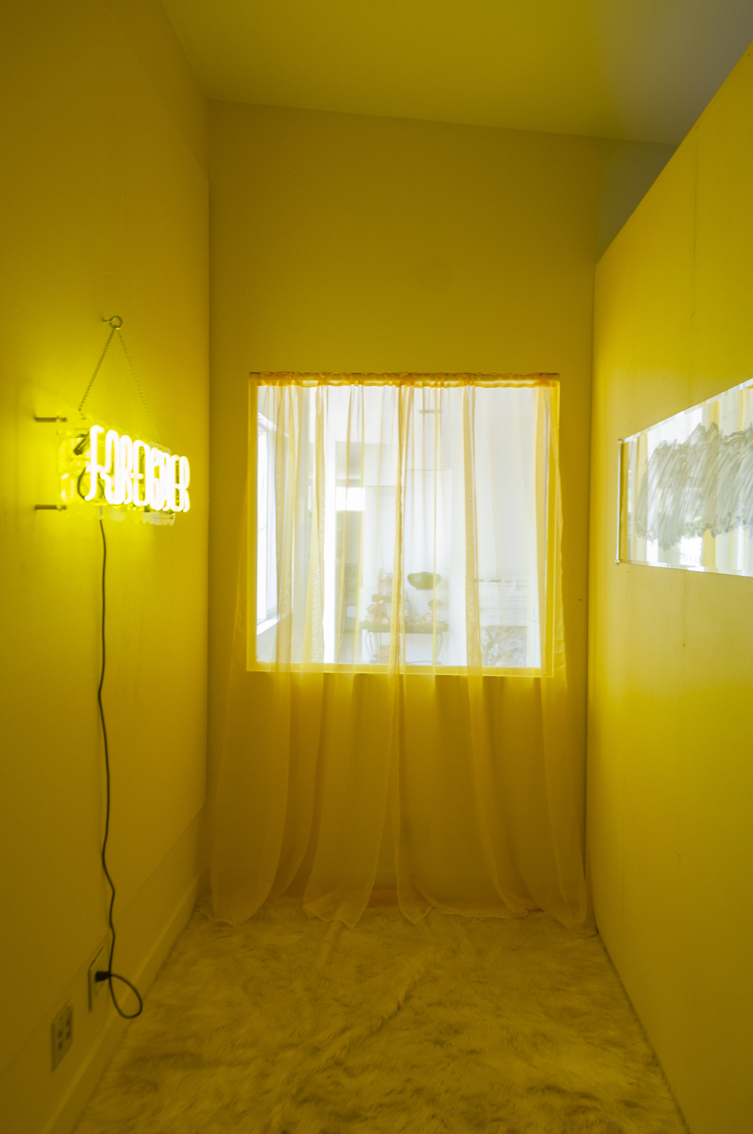  Koreatown Comfort  Multimedia installation: yellow paint, FOREIGNER custom neon sign, mirror, acrylic paint, yellow curtains, shag rug, custom made stud wall.   180” x 84” x 96”   Installation view. 