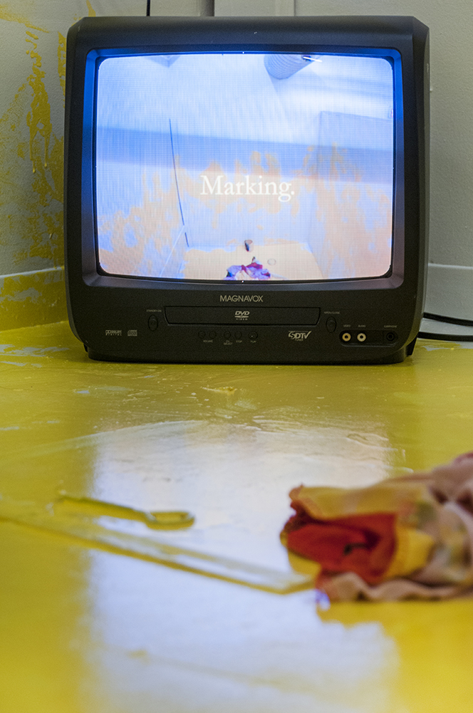  Marking.&nbsp;  Multimedia installation: yellow paint, oriental kimono, Coverall, googles, face mask, paint can, paint opener, documented performance, and television sets.&nbsp;  96x125x96 inches.  Installation view. 