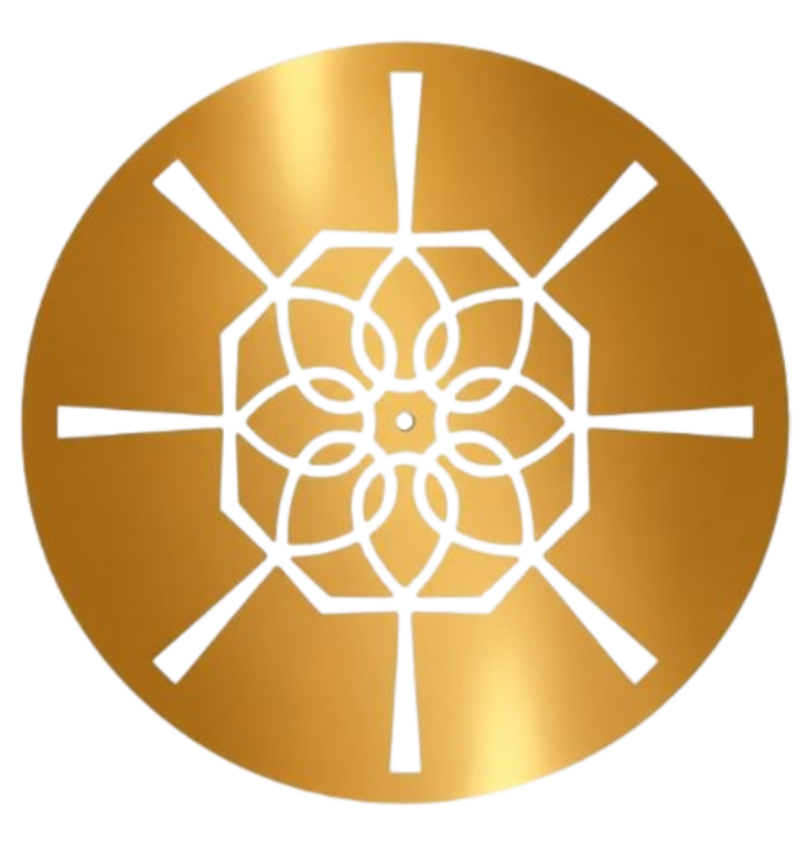 A round, gold-colored clock with black, red, and yellow accents, featuring a floral and geometric design in the center.